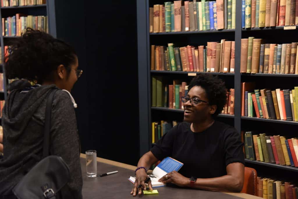Jacqueline Woodson with kid signing
